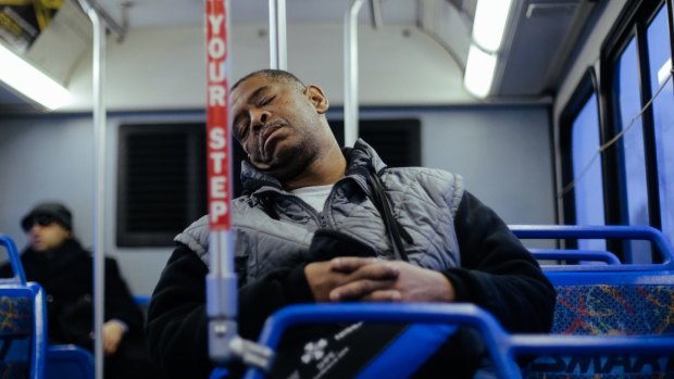 James Robertson takes a brief nap while riding the bus.