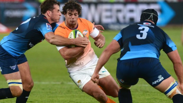 Francois Venter of the Cheetahs is wrapped up by the Bulls defence.