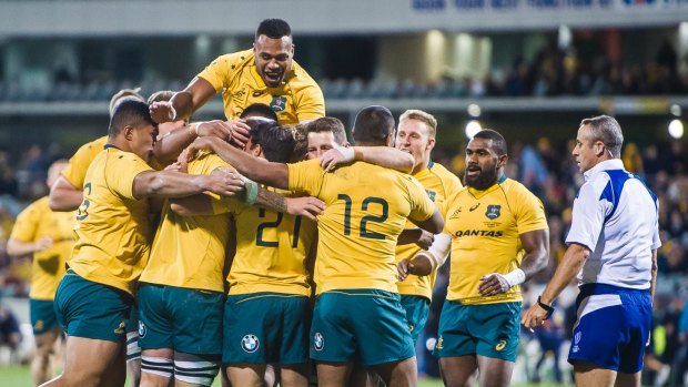 Winning feeling: The Wallabies celebrate victory over Argentina, but a far bigger challenge awaits in South Africa.