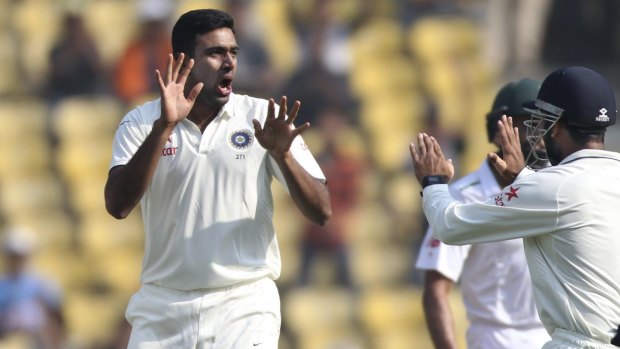 Indian spinner Ravichandran Ashwin, center, celebrates with teammates after claiming the wicket of South African captain Hashim Amla on the second day of the third cricket test match between the two countries in Nagpur, India, Thursday, Nov. 26, 2015. (AP Photo/Rafiq Maqbool)