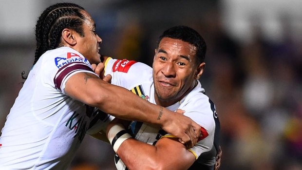 Tautau Moga of the North Queensland Cowboys is tackled by Steve Matai.