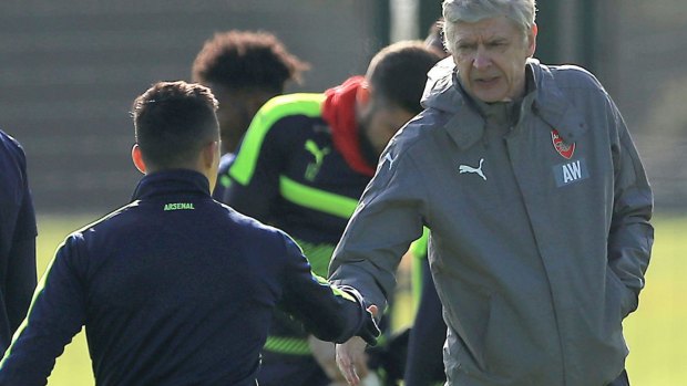 The handshake: Alexis Sanchez and Arsene Wenger settle business at training this week.