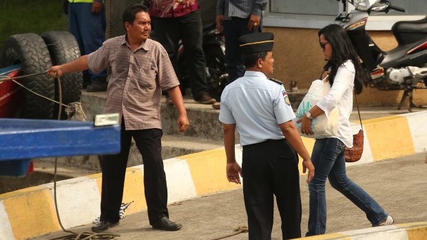 Febyanti Herewila, fiancee of Bali nine member Andrew Chan, walks towards the boat at Wijaya Pura wharf that will take her to Nusakambangan prison island.