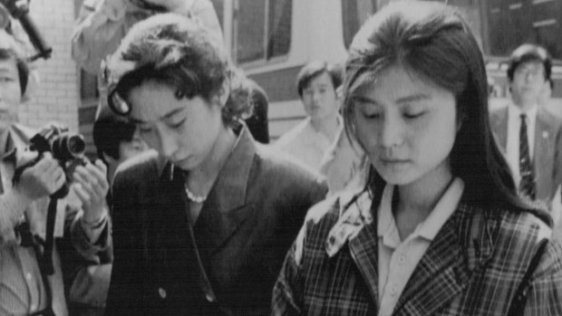 Confessed North Korean agent Kim Hyon-hui, right, enters court during her trial..Kim was sentenced to death for the 1987 bombing of a South Korean airliner, killing 115 people on board.