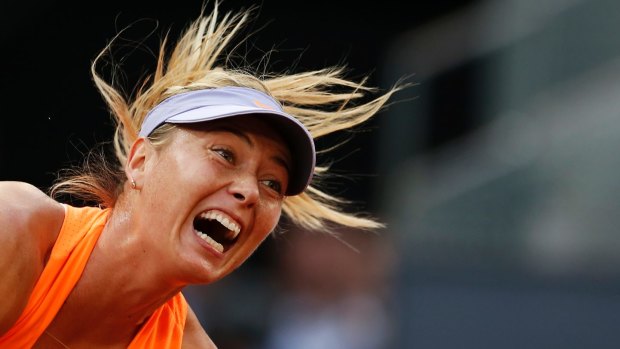 Maria Sharapova serves against Eugenie Bouchard during their Madrid Open tennis tournament match.