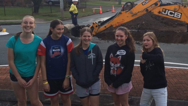 Georgia Abbott, 14, with her friends in the Ferny Hills street where a sinkhole opened up.
