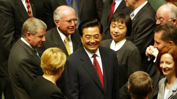October 2003: Jiang's successor, Chinese president Hu Jintao, is congratulated by prime minister John Howard, opposition leader Simon Crean and MPs including future PM Julia Gillard after his address to a joint sitting of Australia's parliament. 