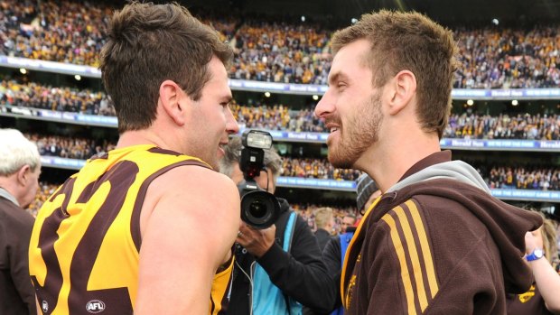 Whitecross (right) congratulates Jonathan Simpkin – who replaced him in the Hawks team – after the 2013 grand final.