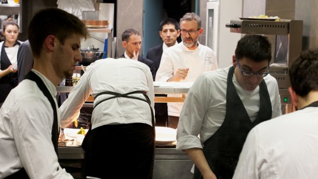 Massimo Bottura (with beard) in the kitchen.