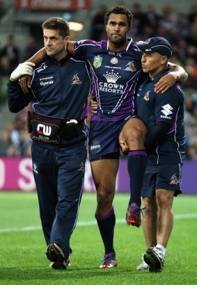 Justin O'Neill is helped off the field by medical staff during the match against the Warriors on Anzac Day.