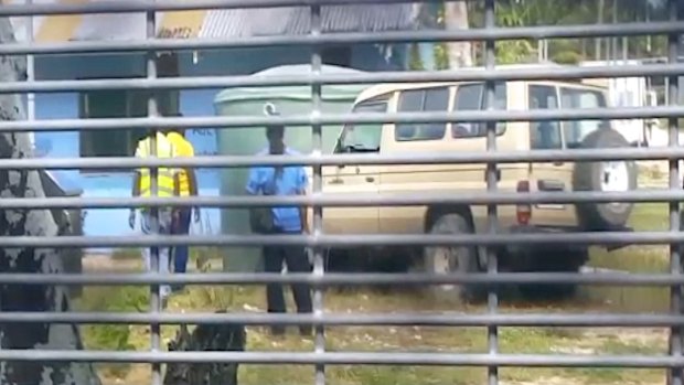 Video footage appears to show authorities using a 4WD to ram rainwater tanks at the centre.