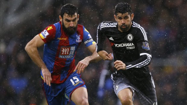 Diego Costa beats Crystal Palace's Mile Jedinak in torrential rain at Selhurst Park on Sunday.