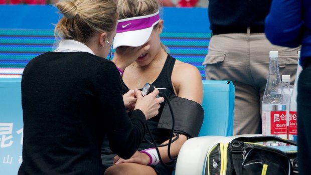 Eugenie Bouchard is assessed by an on court medic during the China Open earlier this month. She was forced to retire.