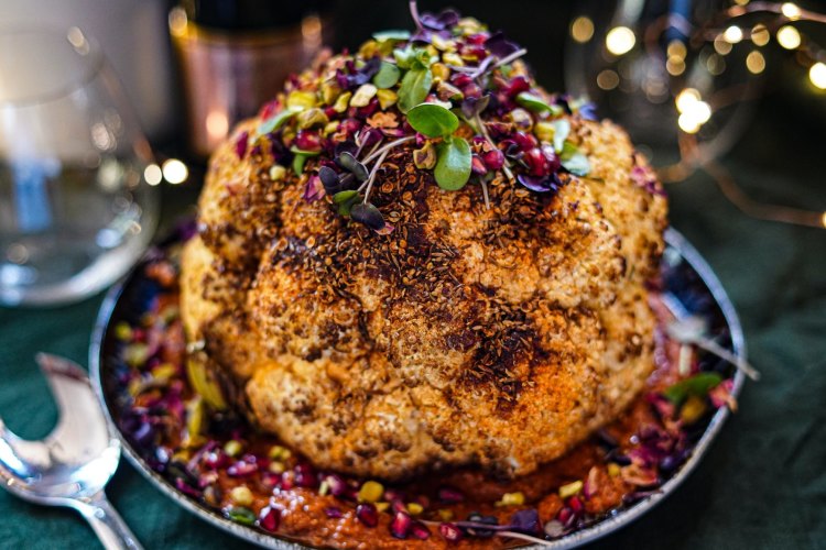 Slow-roasted spiced cauliflower with romesco and herbs.