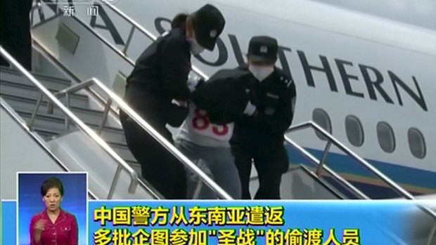A Uighur brought down the stairs of an airplane by police at an unidentified location in China last week. 