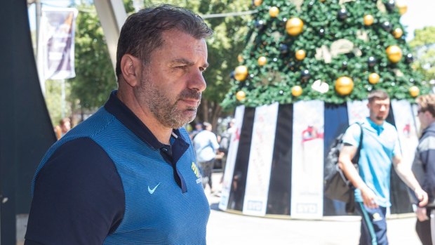 Socceroos coach Ange Postecoglou arrives with team at Sydney Airport on Sunday.