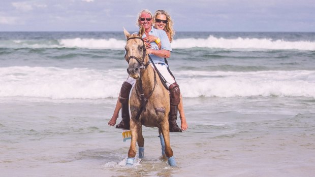 Breaking in: Chris Murphy and wife Caroline ride the waves.