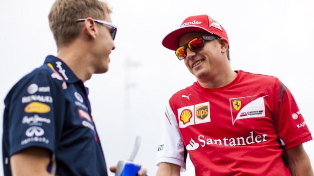 Mates: F1 drivers Sebastian Vettel and Kimi Raikkonen chat at this year's Hungarian Grand Prix in Budapest.