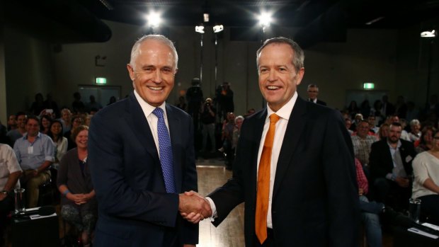 Prime Minister Malcolm Turnbull and Opposition Leader Bill Shorten shake hands at the start of the People's Forum debate at the Windsor RSL.