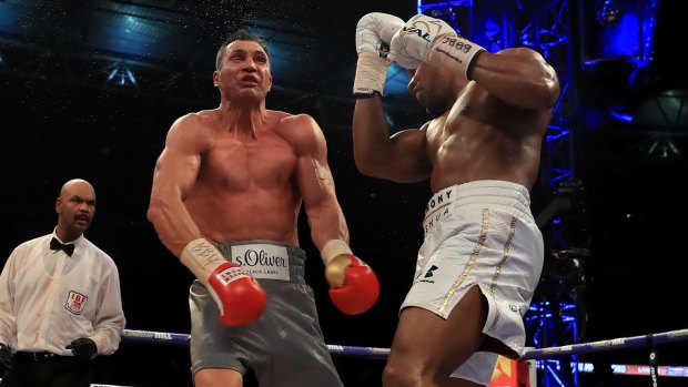 Last man standing: Anthony Joshua (right) knocked Wladimir Kitschko down twice to win.