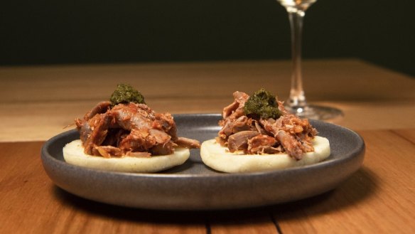 Arepitas topped with confit duck.