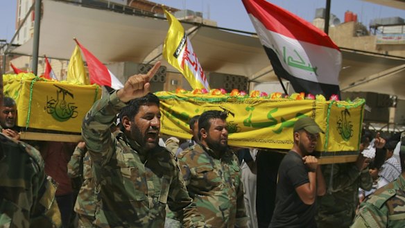 Members of a Shiite militia carry the coffins of their comrades killed fighting outside Fallujah for burial in the Shiite holy city of Najaf. The militias have raised fears of sectarian revenge in Fallujah, a mainly Sunni city.