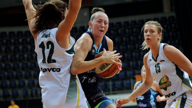 Michelle Cosier, playing for the Canberra Capitals, was known to battle hard on the basketball court.
