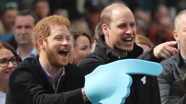 Prince Harry and Prince William urge on runners at the end of the London Marathon.