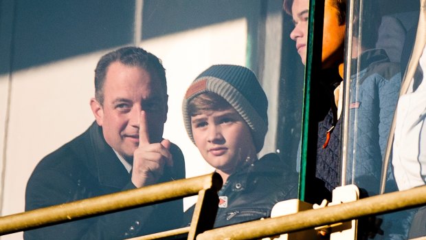 Trump Chief of Staff Reince Priebus, left, and his son Jack, right, watch an Army-Navy college football game in Baltimore.