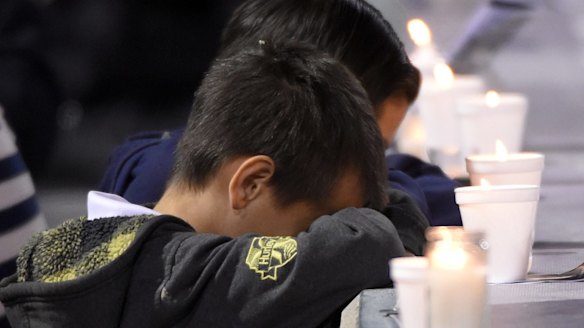 Mourning at a candlelight vigil at San Manuel Stadium in San Bernardino on Wednesday. 
