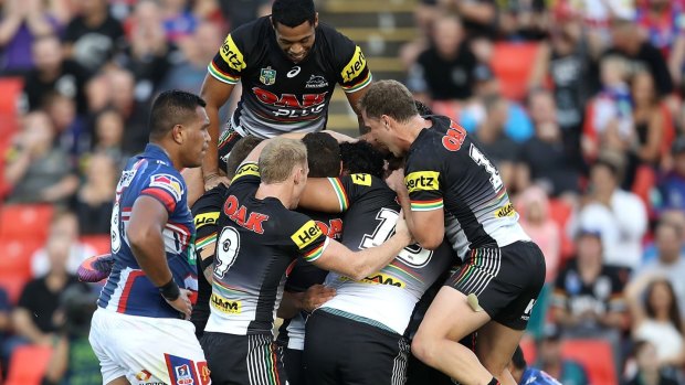 Avalanche: The Panthers jump all over Corey Harawira-Naera after another try.