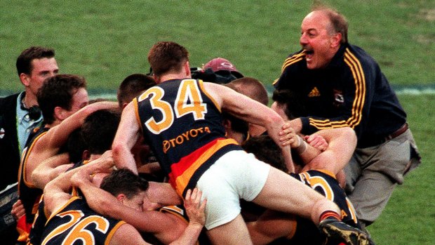 Malcolm Blight celebrates the 1998 grand final win with his players.