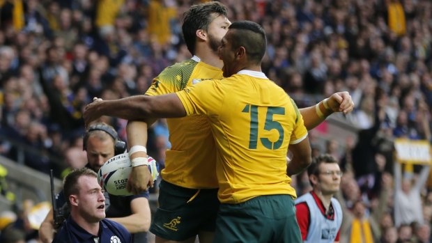 Dynamic duo: Kurtley Beale and Adam Ashley-Cooper celebrate a try during Australia's thrilling win over Scotland.