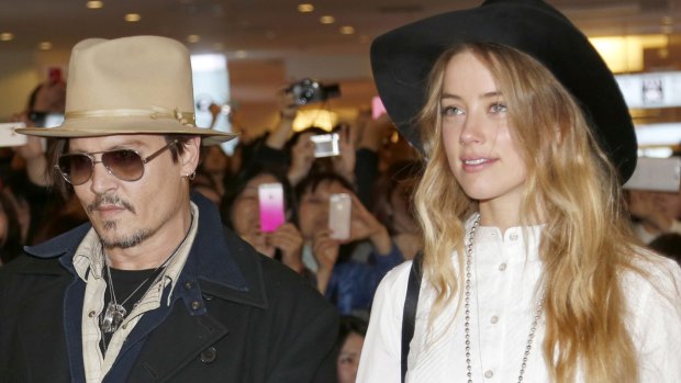 Amber Heard and Johnny Depp, pictured in 2015, will settle their divorce case.