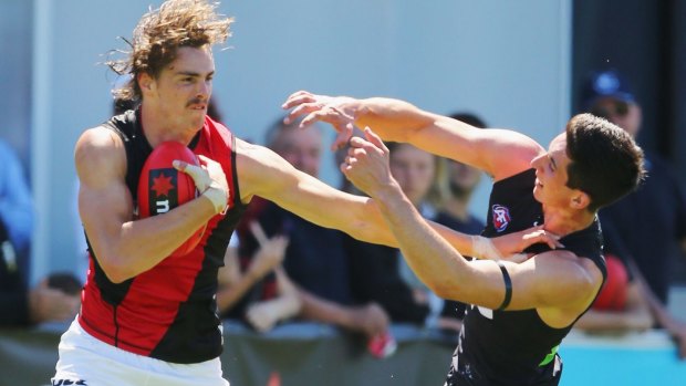 Welcome to the big time: Joe Daniher fends off No.1 draft pick Jacob Weitering.
