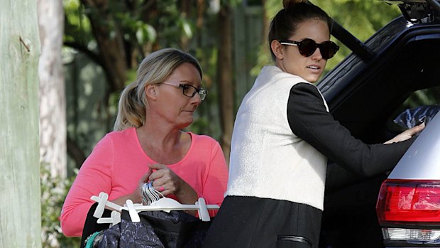 Agent Sharon Finnigan, left, loads up Jesinta Campbell's Jeep