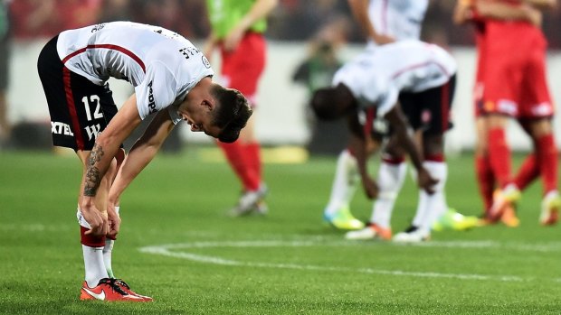 Scott Neville of the Wanderers is dejected after his side lost the A-League title to Adelaide United in Adelaide on Sunday.