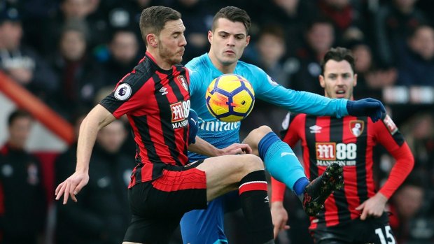 Bournemouth's Dan Gosling and Arsenal's Granit Xhaka fight for te ball at Vitality Stadium in Bournemouth on Sunday.