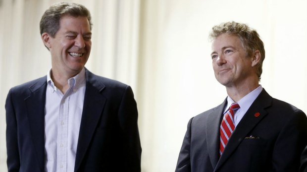 US Senator and presidential candidate Rand Paul at a 2014 rally in support of Republican Kansas Governor Sam Brownback, left.