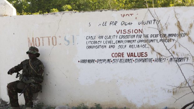 A Kenya Defence Forces soldier secures the area around the Garissa University college, in Garissa, Kenya, Thursday, April 2, 2015.