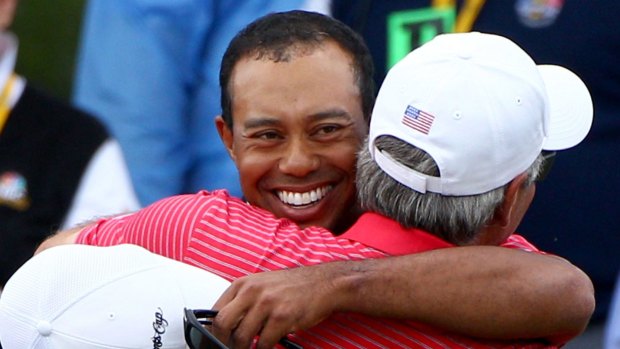 Tiger Woods and Fred Couples embrace at the 2011 Presidents Cup at Royal Melbourne
