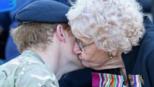 Prince Harry meets Daphne Dunne, who is wearing her husband's Victoria Cross.