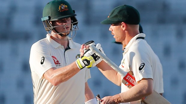 On the road to recovery: Steve Smith congratulates David Warner on reaching 50 runs.