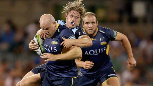 Wallabies clash: Stephen Moore of the Brumbies is tackled by Michael Hooper of the Waratahs.