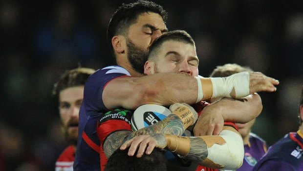 We meet again: Josh Dugan is wrapped up by Jesse Bromwich during Saturday night's match.