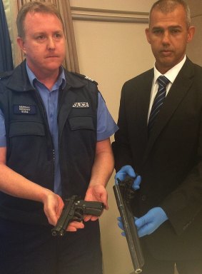 Cockburn police sergeant Josh Murray and Fremantle senior detective sergeant Michael Rowson with weapons seized during operation First Edition.