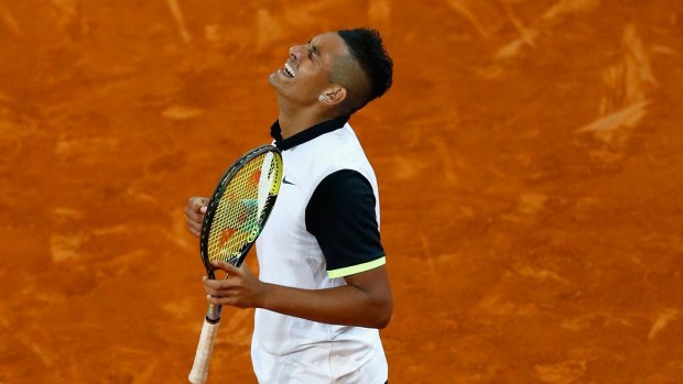 Nick Kyrgios celebrates defeating Roger Federer during day five of the Mutua Madrid Open.