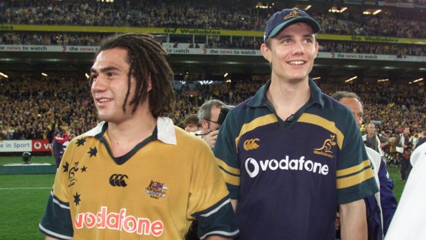 Special one: George Smith with Stephen Larkham, but they'll be backing rival sides when the Reds come to Canberra next year .