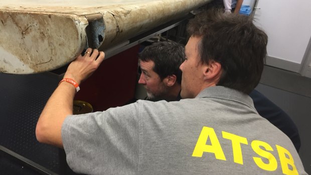 Malaysian and Australian investigators examine the piece of aircraft debris found on Pemba Island off the coast of Tanzania