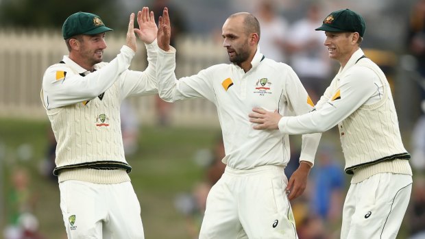 No mercy: Nathan Lyon is congratulated by Shaun Marsh and Adam Voges after dismissing Rajendra Chandrika in Hobart.